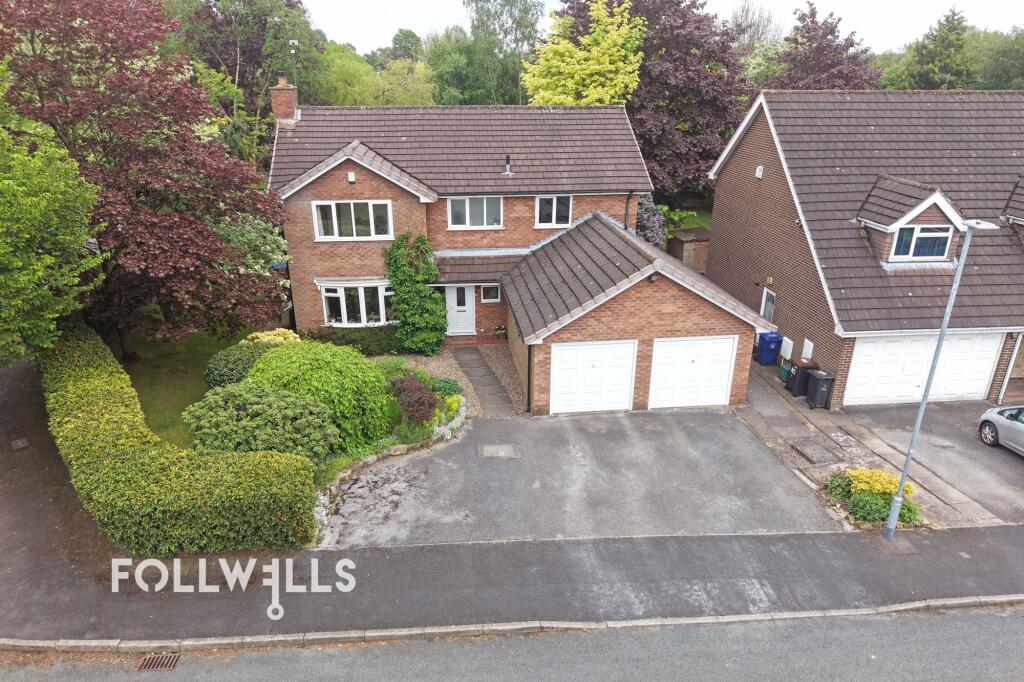 Exterior view of a detached brick property on Alderney Road with a driveway, garage and mature front garden.